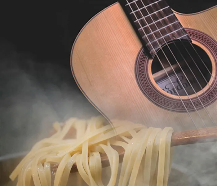 Close-up of a guitar with uncooked fettuccine pasta on its body, surrounded by steam.